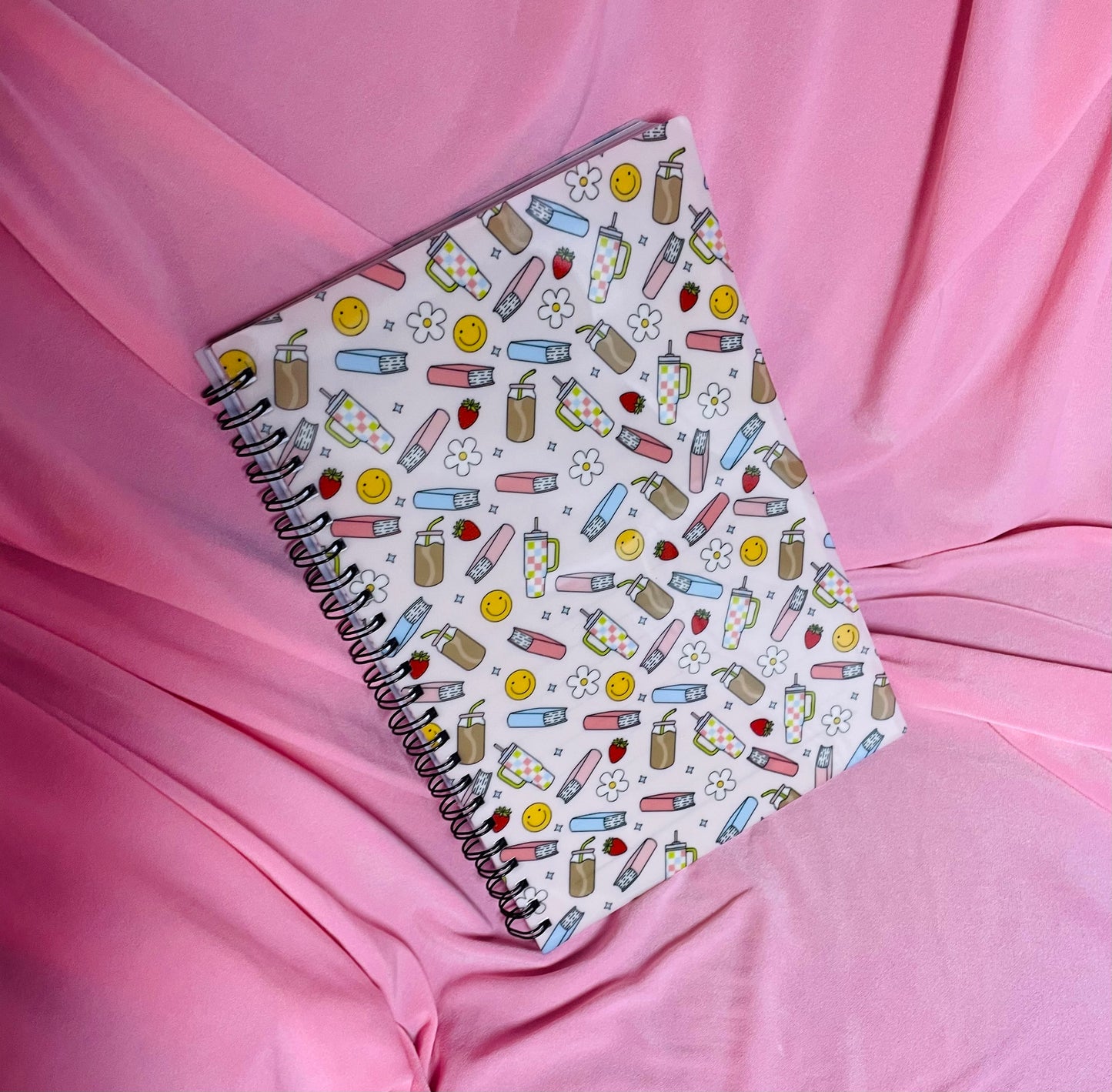 Books, iced coffee and smileys notebook
